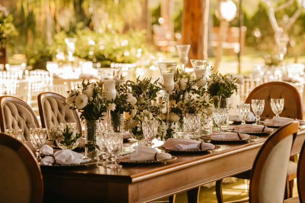 Outdoor reception tables laid with glassware and flowers